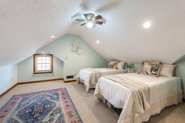 bedroom with lofted ceiling, light carpet, a textured ceiling, and ceiling fan