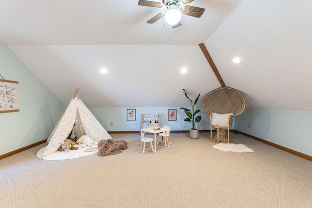 recreation room featuring lofted ceiling, ceiling fan, and carpet flooring