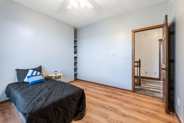 bedroom with hardwood / wood-style floors and ceiling fan