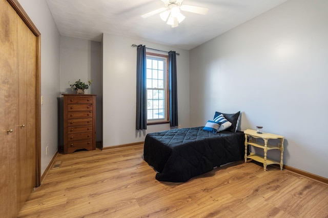 bedroom featuring light hardwood / wood-style floors, a closet, and ceiling fan