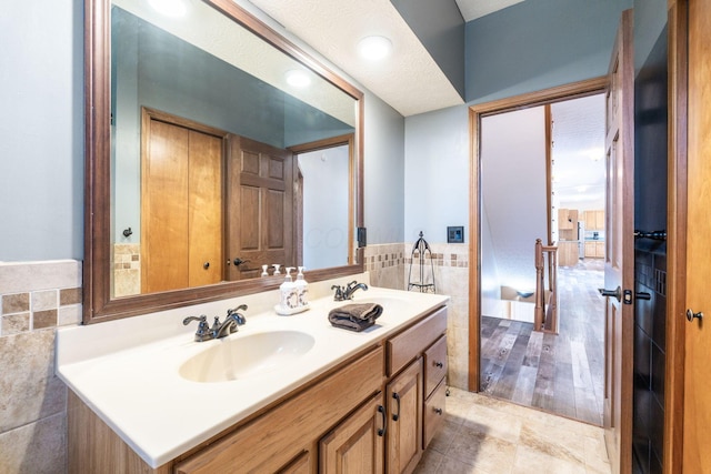 bathroom featuring tile walls and vanity