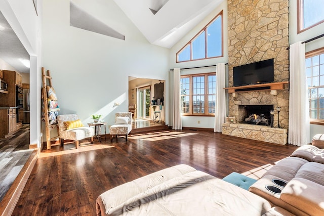 living room with hardwood / wood-style flooring, a fireplace, high vaulted ceiling, and a wealth of natural light