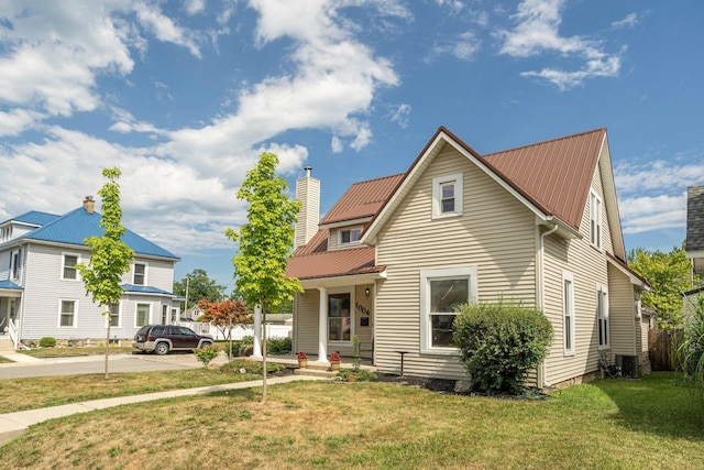 view of front facade featuring cooling unit and a front yard