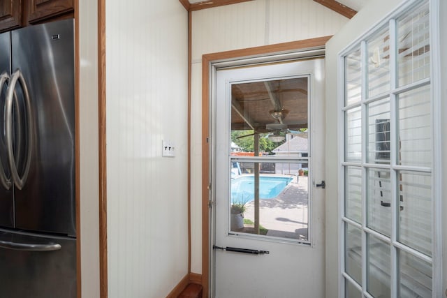 doorway with wood walls