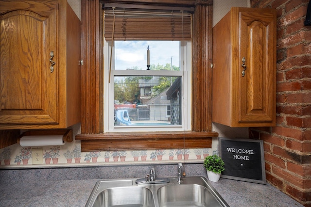 kitchen with brick wall and sink