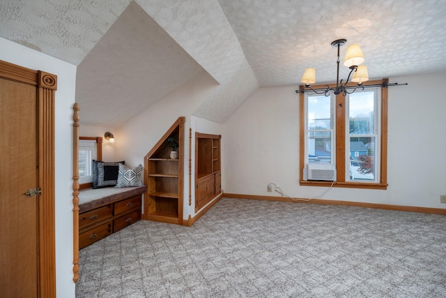 bonus room with cooling unit, vaulted ceiling, a textured ceiling, light colored carpet, and a chandelier