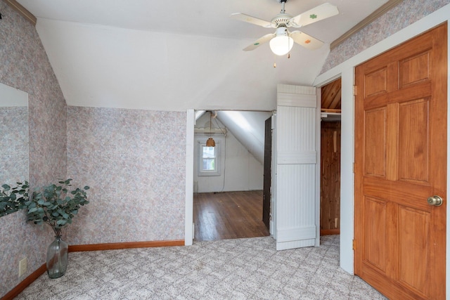 additional living space with ceiling fan, lofted ceiling, and light wood-type flooring