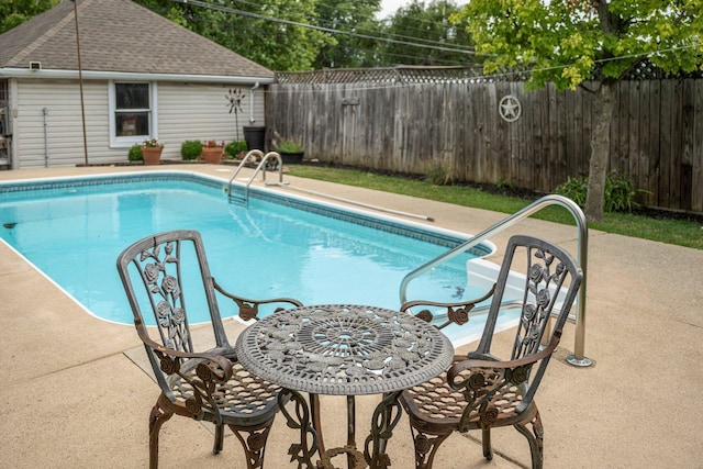 view of swimming pool with a patio