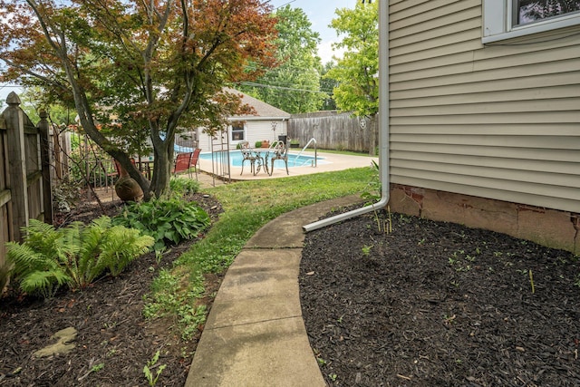 view of yard with a fenced in pool and a patio area