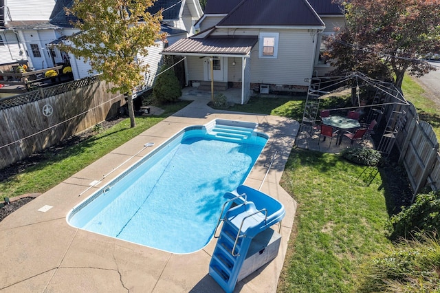 view of swimming pool with a lawn and a patio area