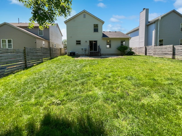 rear view of house with a yard