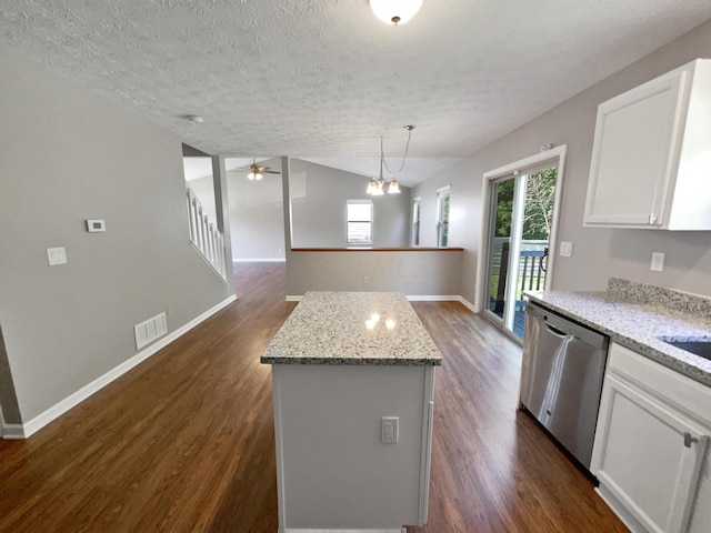 kitchen featuring pendant lighting, stainless steel dishwasher, a kitchen island, dark hardwood / wood-style flooring, and white cabinetry