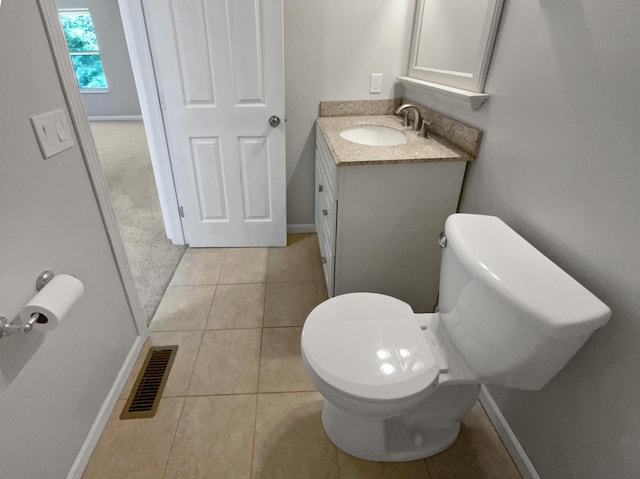 bathroom featuring tile patterned flooring, vanity, and toilet