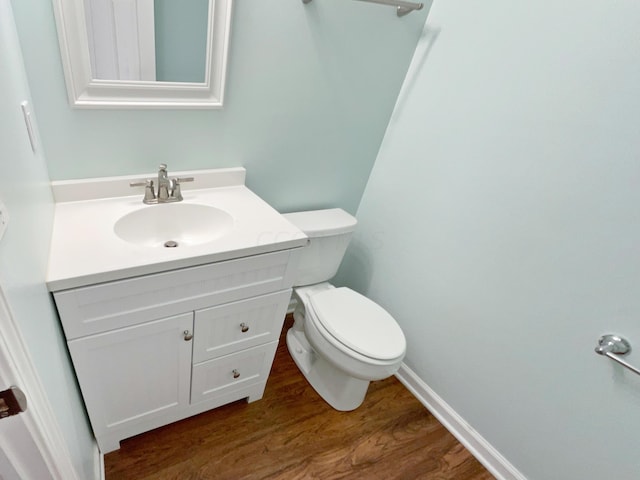 bathroom featuring hardwood / wood-style floors, vanity, and toilet