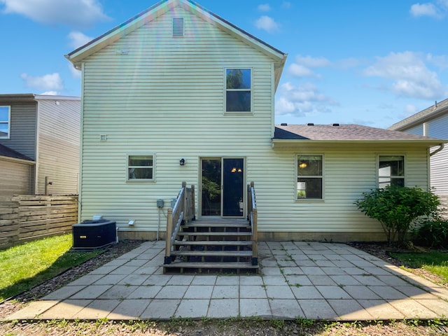 back of house with a patio area and central AC