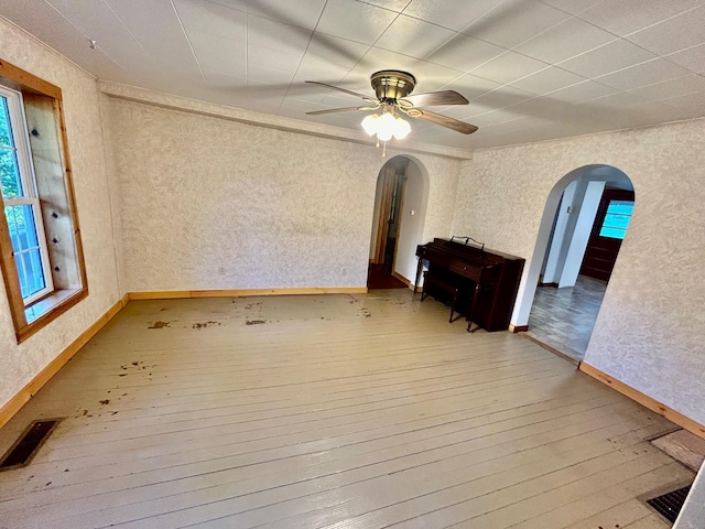 spare room with wood-type flooring and ceiling fan