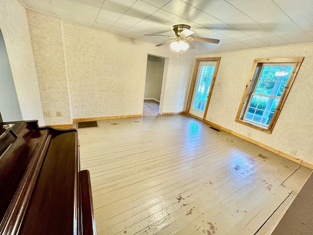 spare room featuring wood-type flooring and ceiling fan