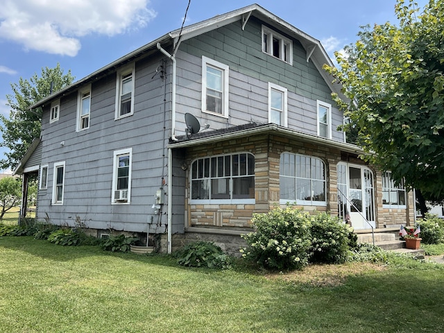 back of house with a lawn