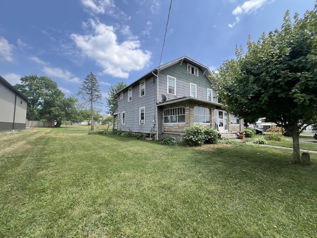 view of side of home featuring a lawn