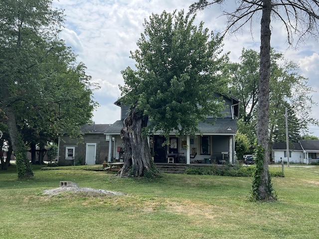 exterior space featuring a lawn and covered porch