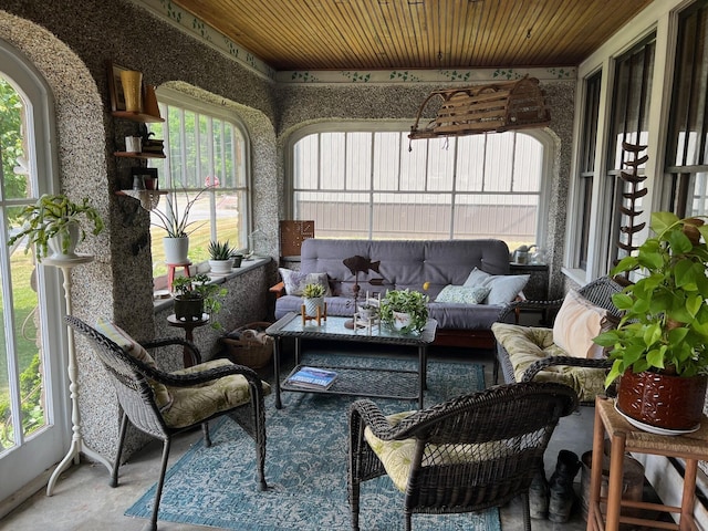 sunroom / solarium with a healthy amount of sunlight and wooden ceiling