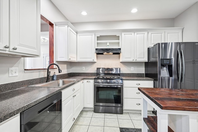 kitchen featuring light tile patterned floors, stainless steel appliances, white cabinetry, and sink