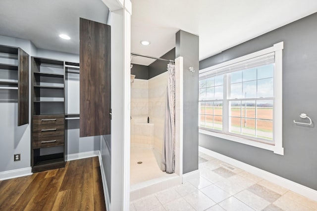 bathroom with hardwood / wood-style floors and a shower with curtain