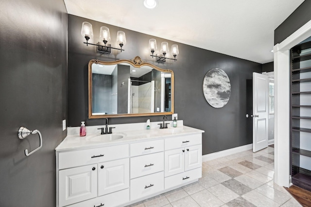 bathroom featuring a shower with door, vanity, and tile patterned flooring