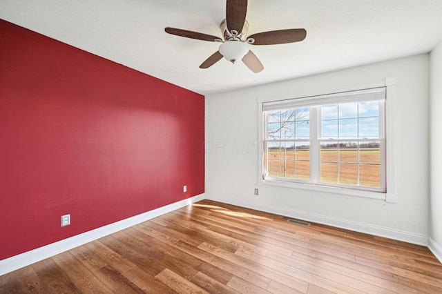 spare room featuring hardwood / wood-style flooring and ceiling fan