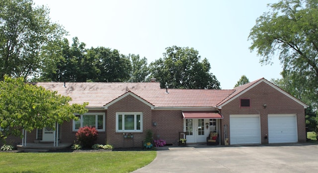 ranch-style home featuring a front yard and a garage