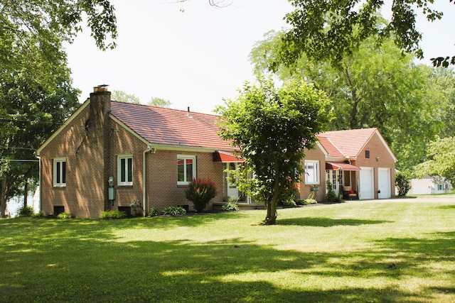 exterior space with a garage and a yard