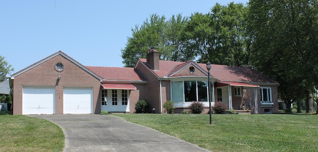 view of front of home with a garage and a front yard