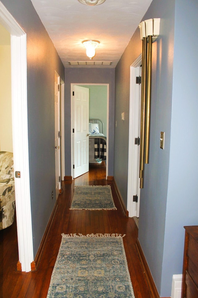 hallway featuring dark hardwood / wood-style flooring