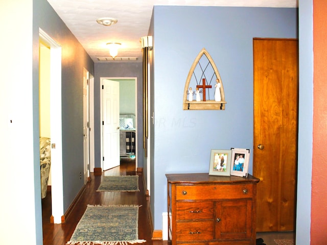 hall with dark hardwood / wood-style flooring