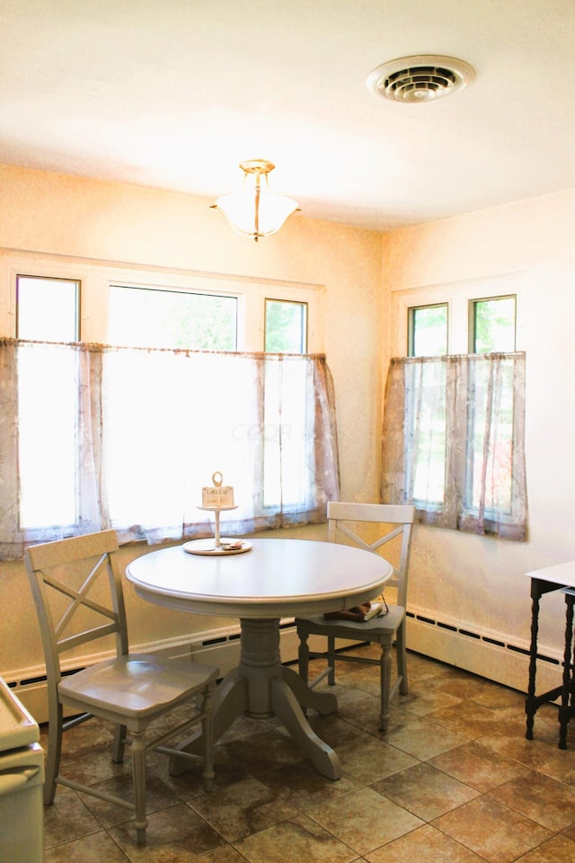 dining space featuring baseboard heating