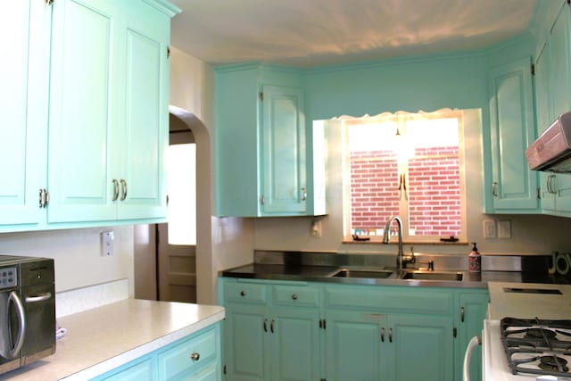 kitchen featuring extractor fan, white range with gas cooktop, and sink