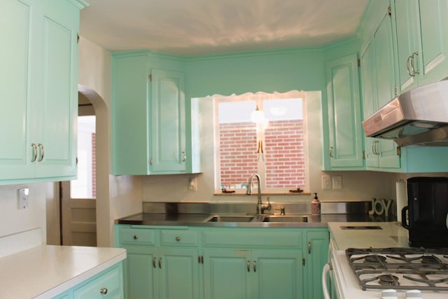 kitchen with white gas range and sink