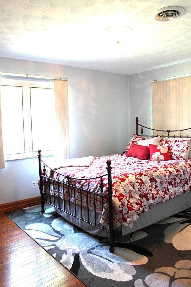 bedroom with hardwood / wood-style floors