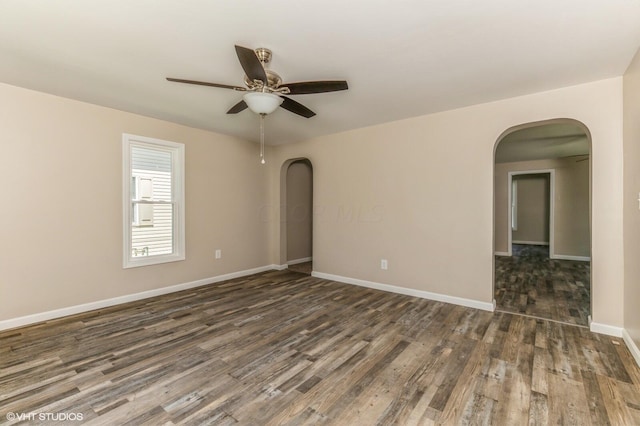 unfurnished room with dark hardwood / wood-style floors and ceiling fan