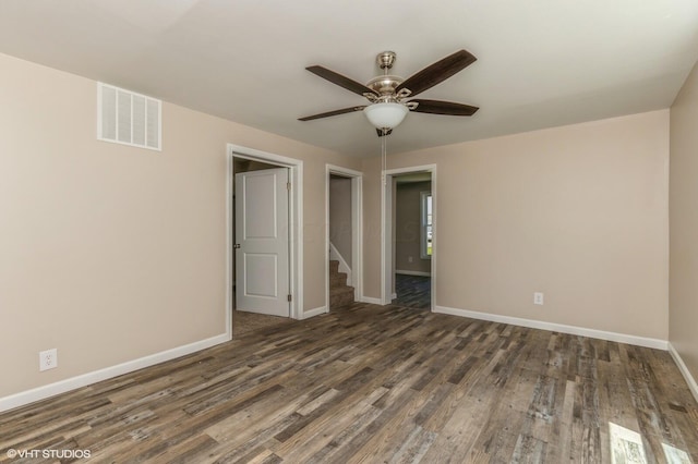 unfurnished bedroom with ceiling fan and dark hardwood / wood-style floors