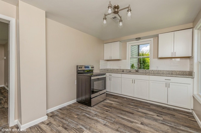 kitchen featuring white cabinets, dark hardwood / wood-style flooring, and electric range