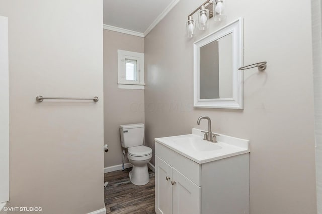 bathroom featuring hardwood / wood-style floors, vanity, toilet, and crown molding