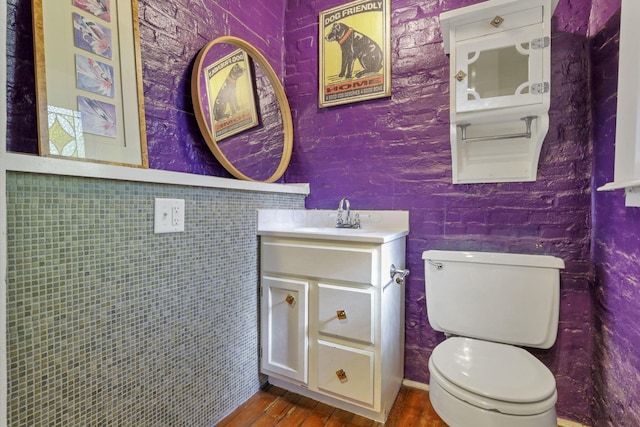 bathroom featuring hardwood / wood-style flooring, vanity, and toilet