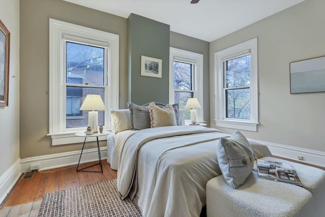 bedroom with ceiling fan and wood-type flooring