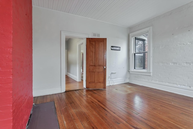 unfurnished room with hardwood / wood-style flooring