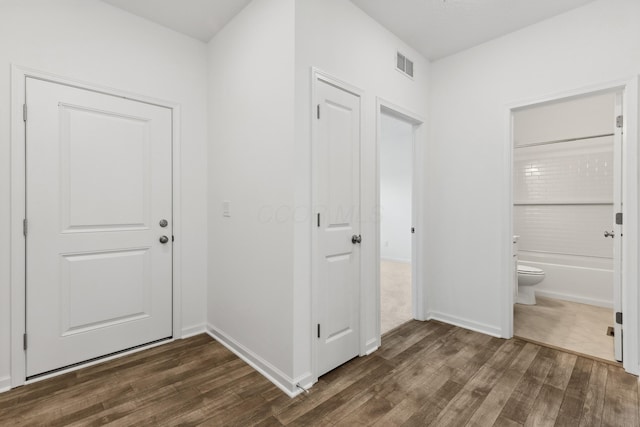 hallway with dark wood-type flooring