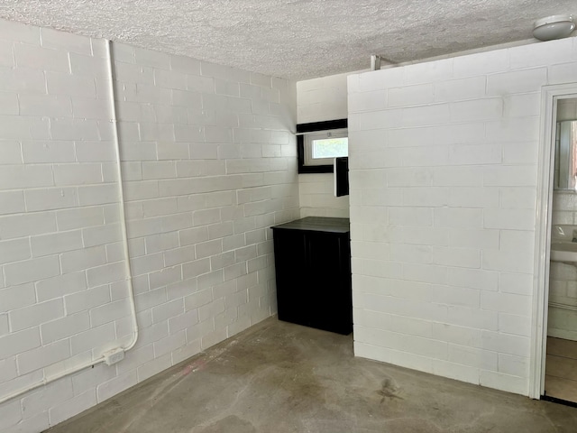 basement featuring a textured ceiling