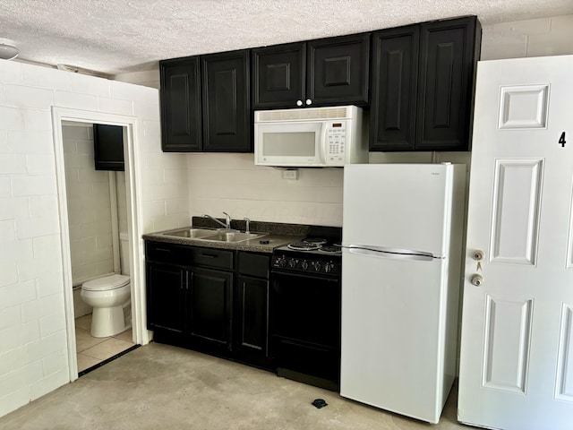 kitchen featuring a textured ceiling, sink, and white appliances