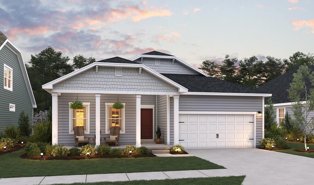 view of front facade with a lawn and a garage