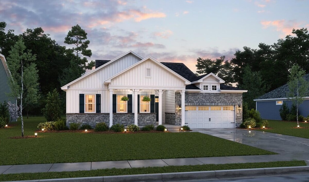 view of front of property featuring a yard and a garage